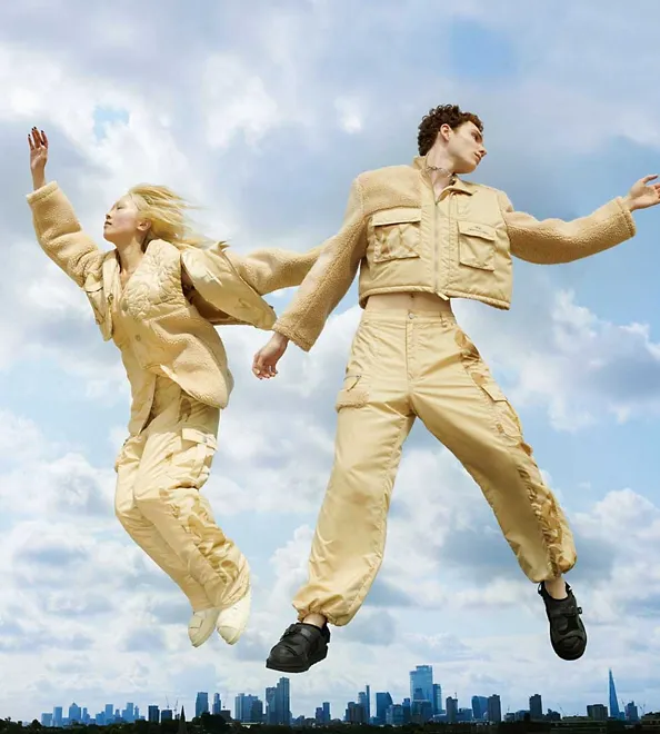 Models floating in the air wearing UGG X Feng Chen Wang Convertible Jacket, Cargo Pant and Tasman.