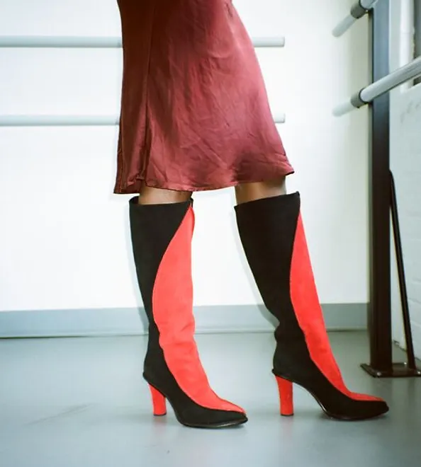 Person with a red dress is wearing the Fatale Boot.