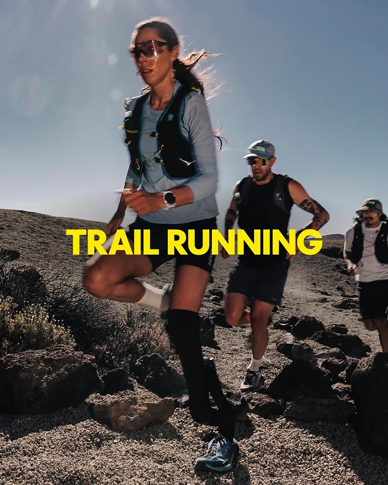 A few athletes wearing HOKA gear running on terrain.