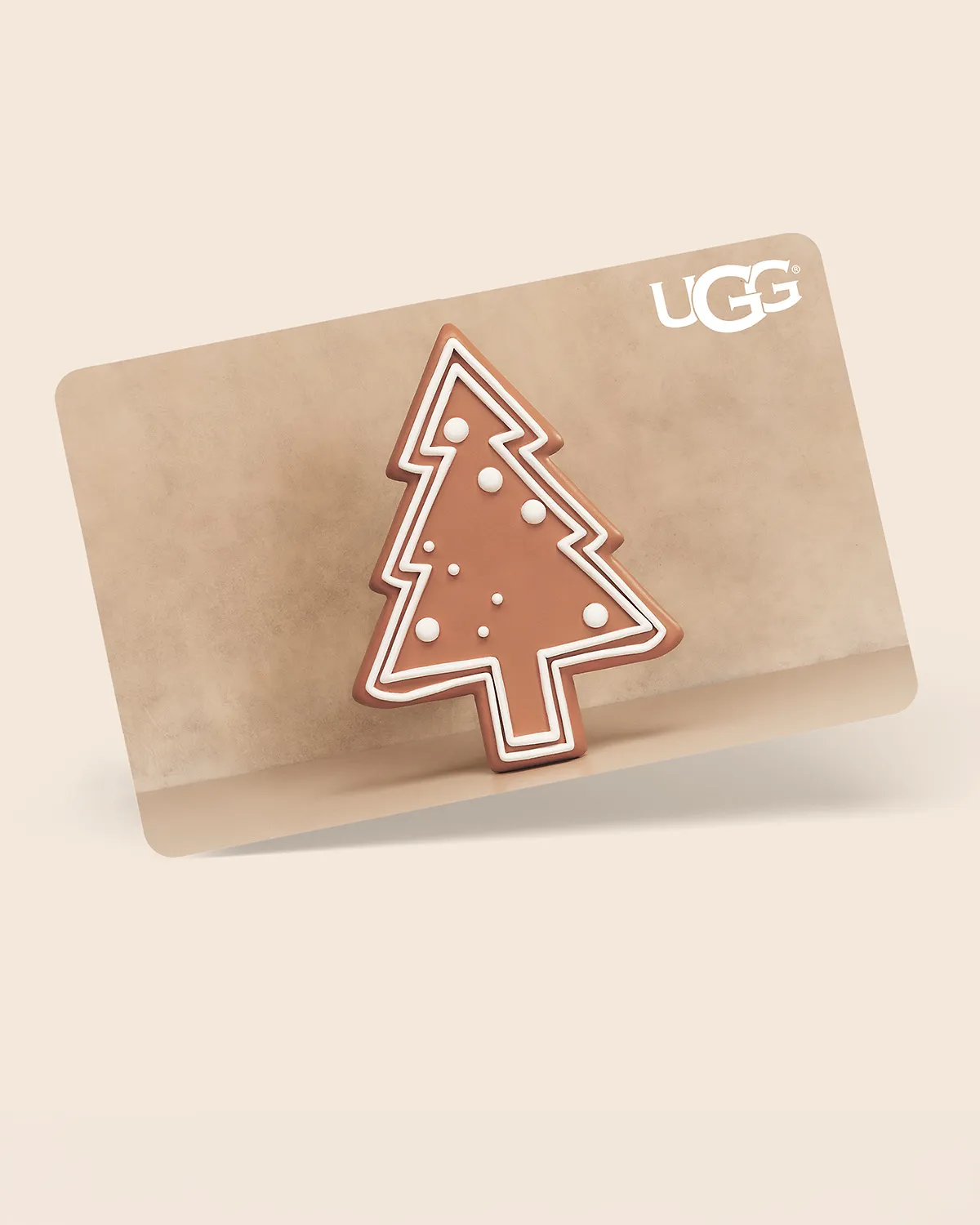 An UGG gift card featuring a gingerbread tree design.