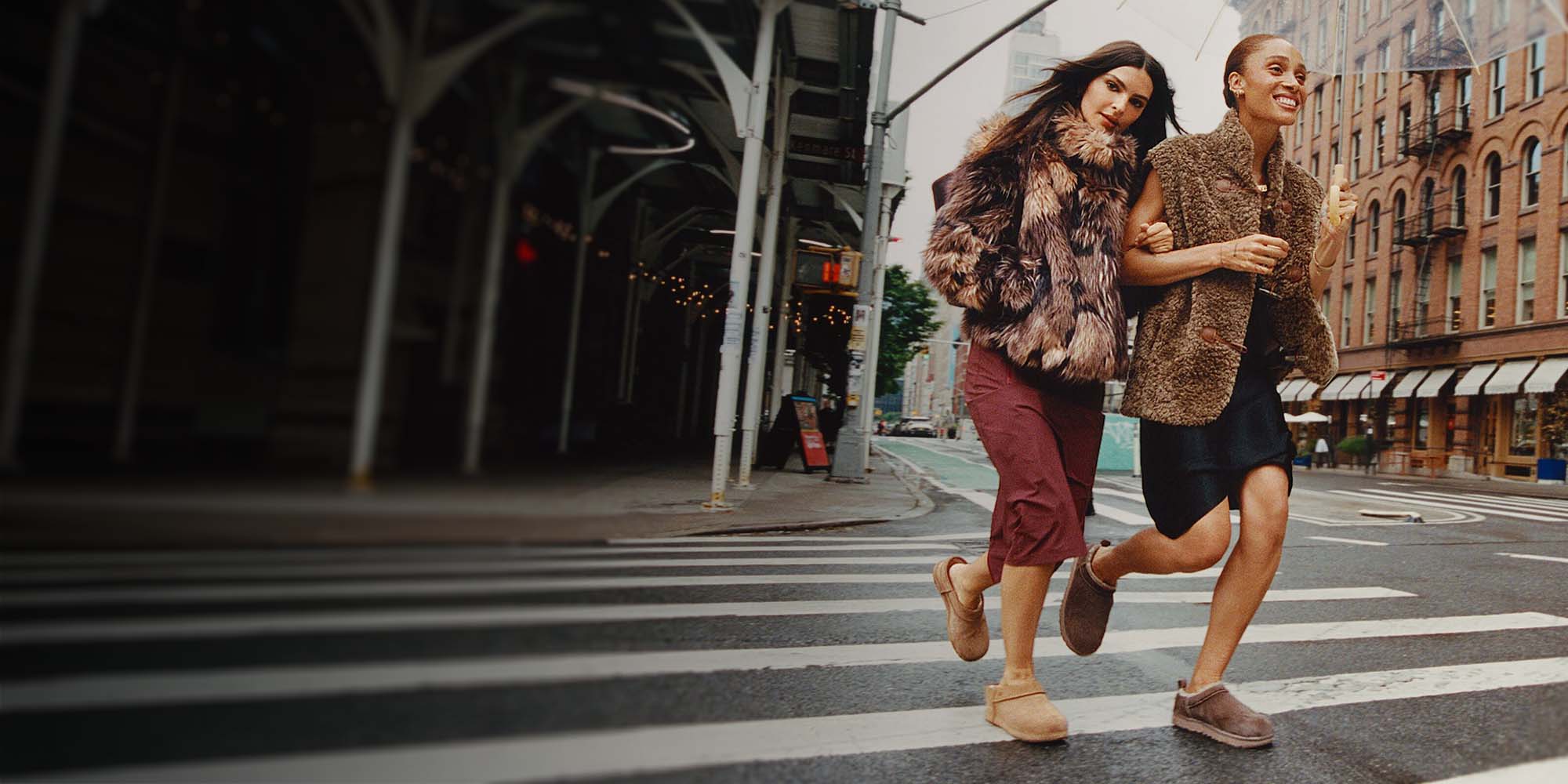 Two women crossing the street wearing UGG Classic Micro Calf Hair boots
