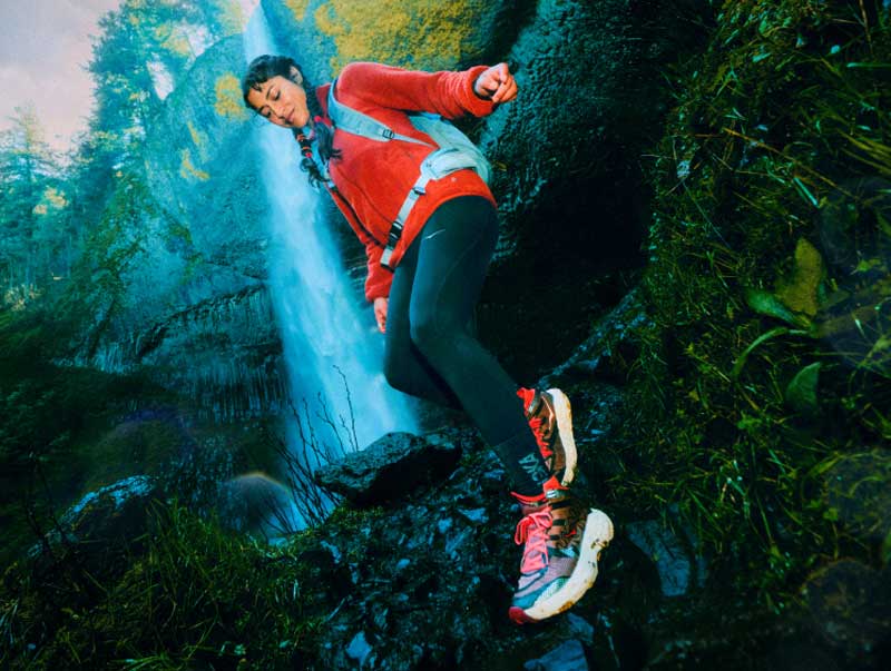 Femme courant dans une forêt tropicale portant la chaussure Speedgoat 7 Hike GTX.