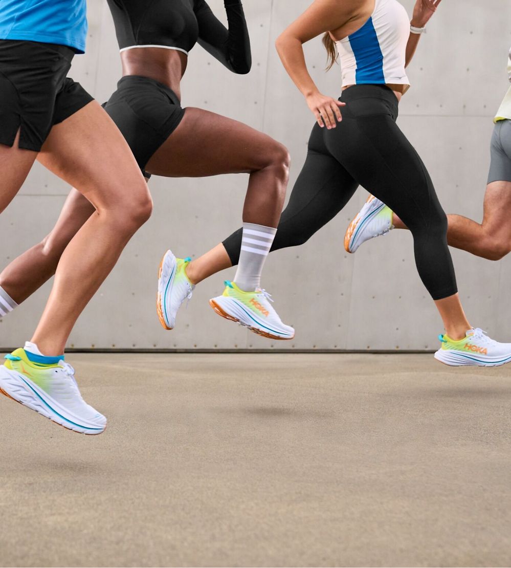 Group of people running wearing HOKA shoes.