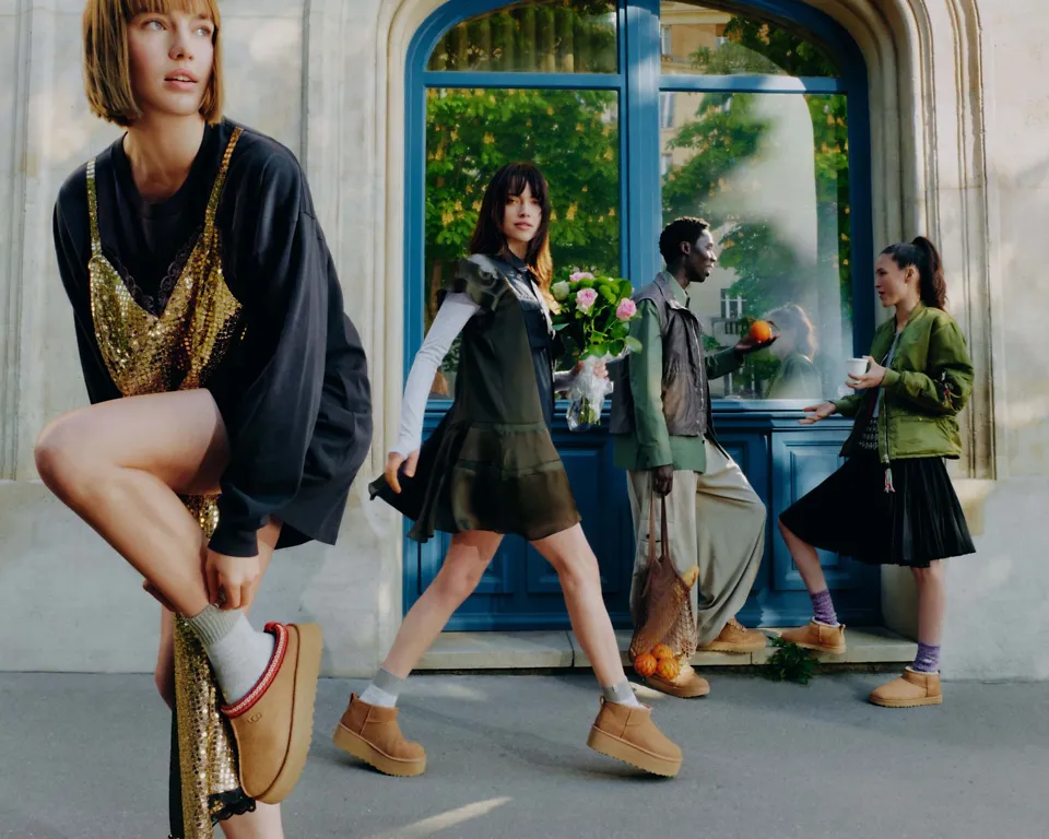 People on the sidewalk, wearing Classic Ultra Mini Platform, Tazz II, Classic Ultra Mini and Lowmel sneakers.