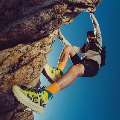 Man climbing a rock while wearing the Mafata X Hike.
